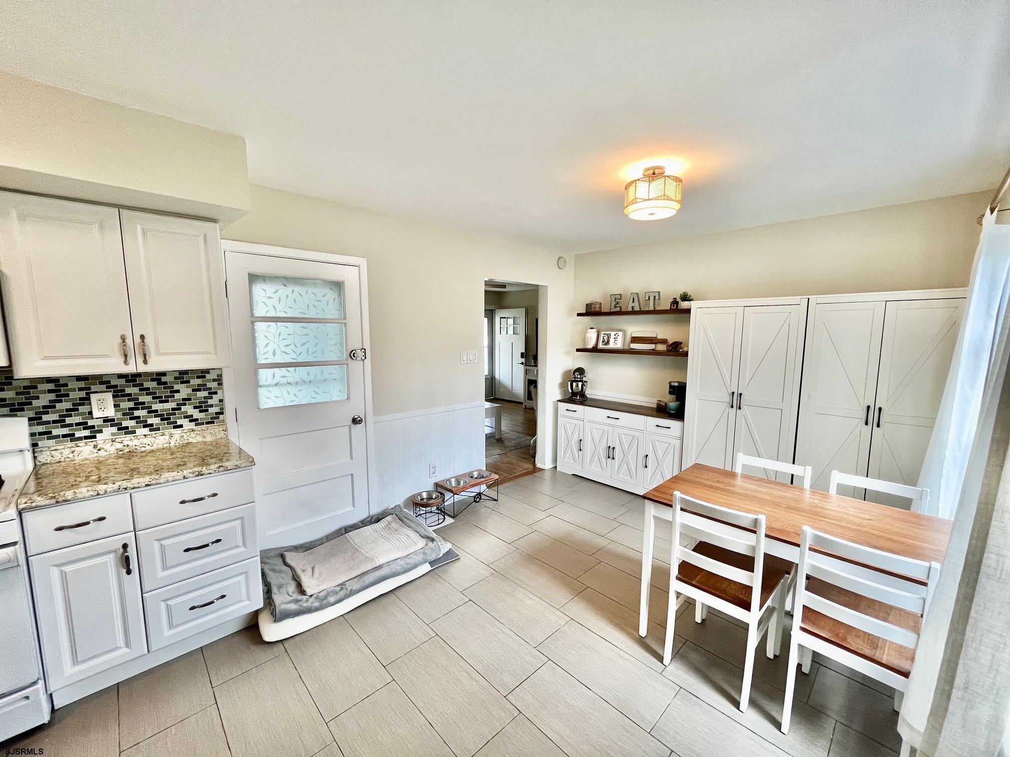 415 Rhode Island Avenue Somers Point, NJ 08244 - Photo 9 of 30 a kitchen with white cabinets and window
