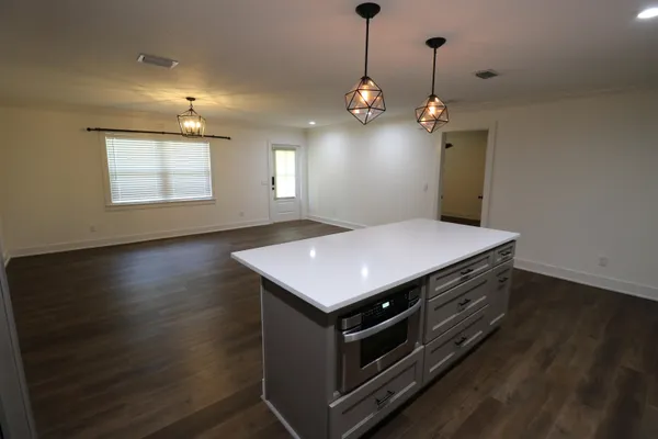 a kitchen with a stove double vanity and window