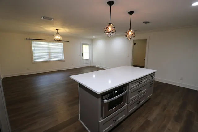 a kitchen with a stove double vanity and window