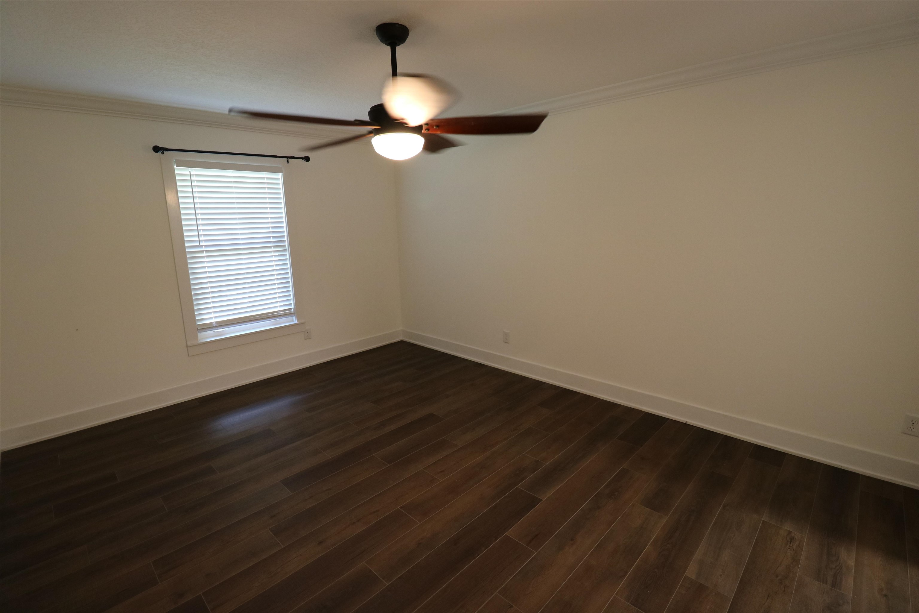 140 Seminole Road St. Augustine, FL 32086 - Photo 12 of 26 an empty room with wooden floor fan and windows