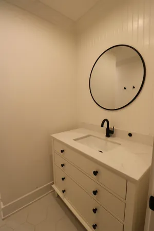 a bathroom with a sink and mirror