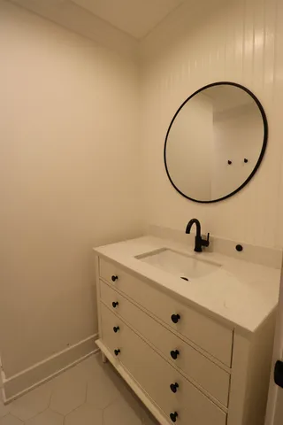 a bathroom with a sink and mirror