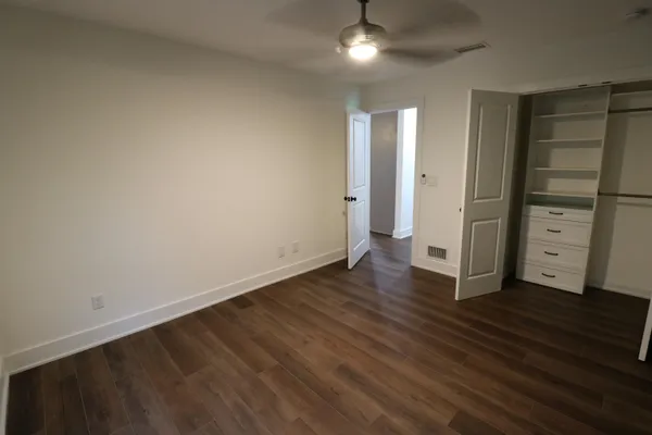 an empty room with wooden floor