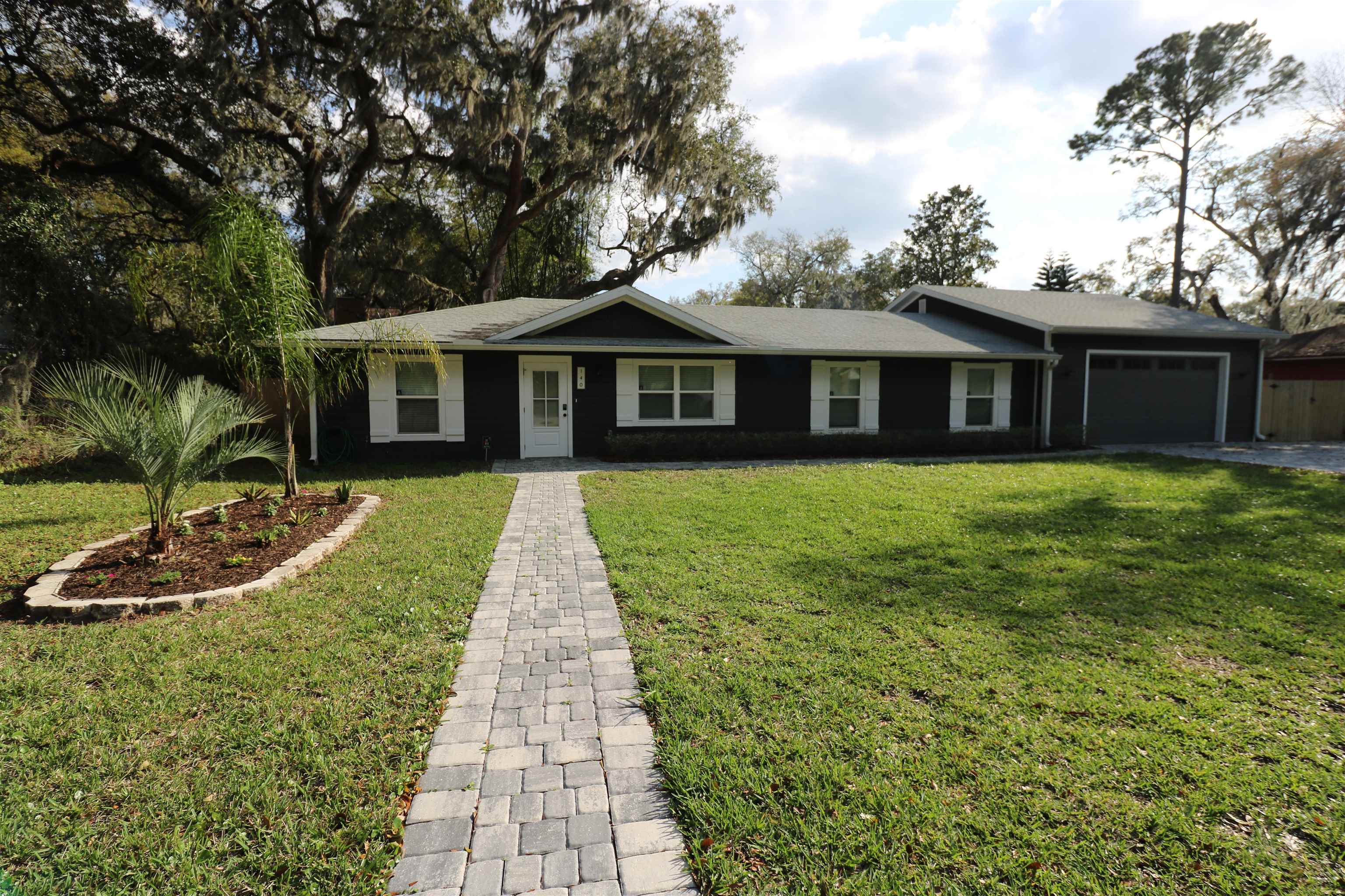140 Seminole Road St. Augustine, FL 32086 - Photo 2 of 26 a view of a house with a yard and potted plants