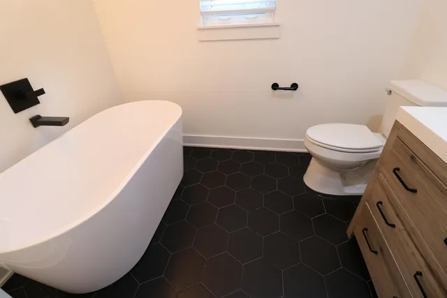 a bathroom with a toilet and a mirror