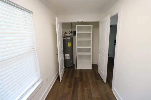 a view of walk in closet with empty racks