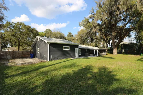 a front view of house with yard and trees