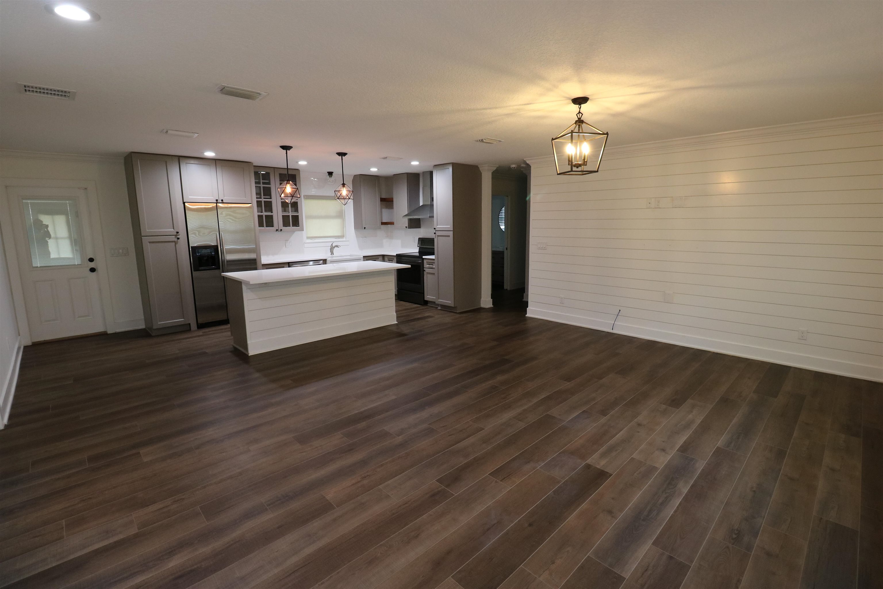 140 Seminole Road St. Augustine, FL 32086 - Photo 6 of 26 a large kitchen with a wooden floor and chandelier