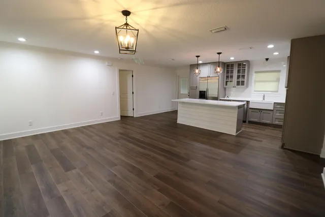 a view of kitchen and living room with wooden floor