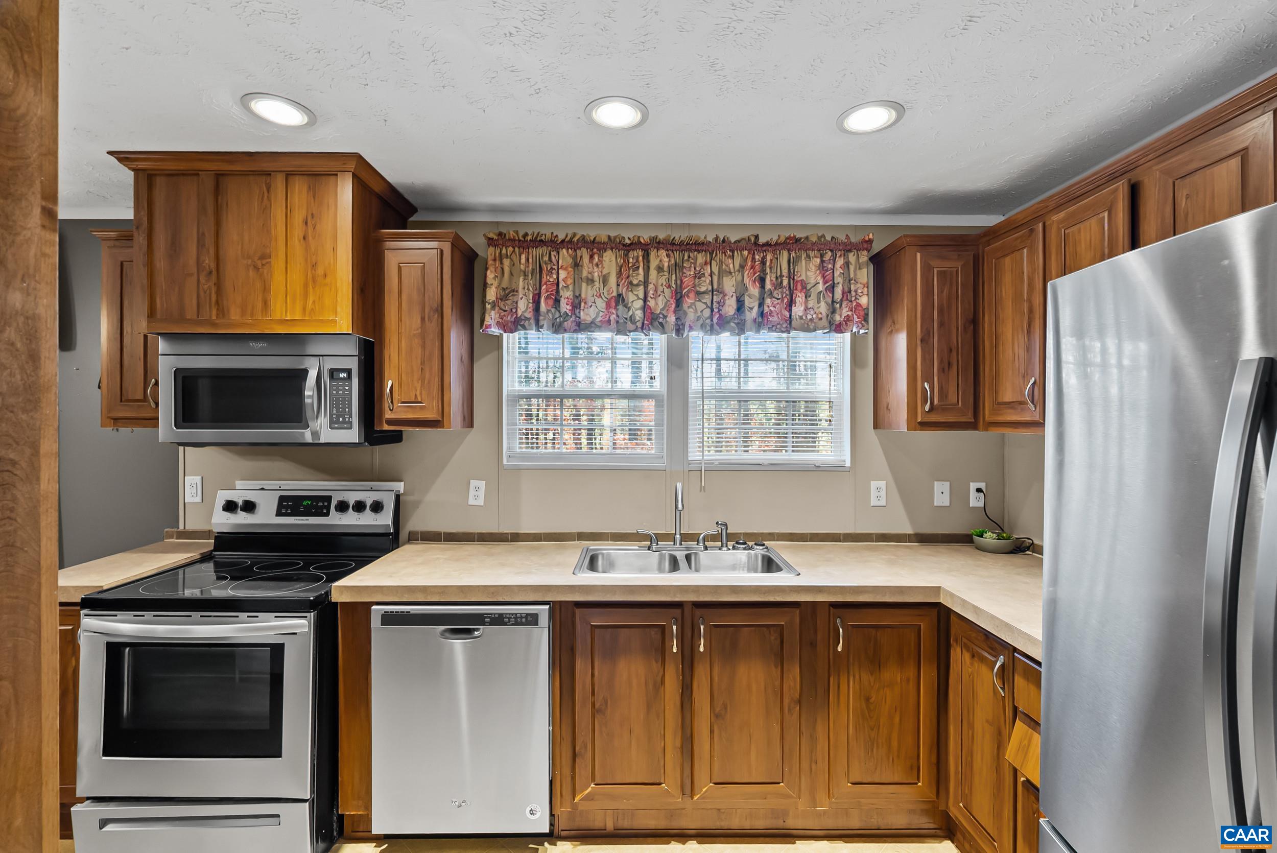 1690 Poorhouse Creek Road Appomattox, VA 24522 - Photo 11 of 44 a kitchen with stainless steel appliances granite countertop a sink stove and refrigerator
