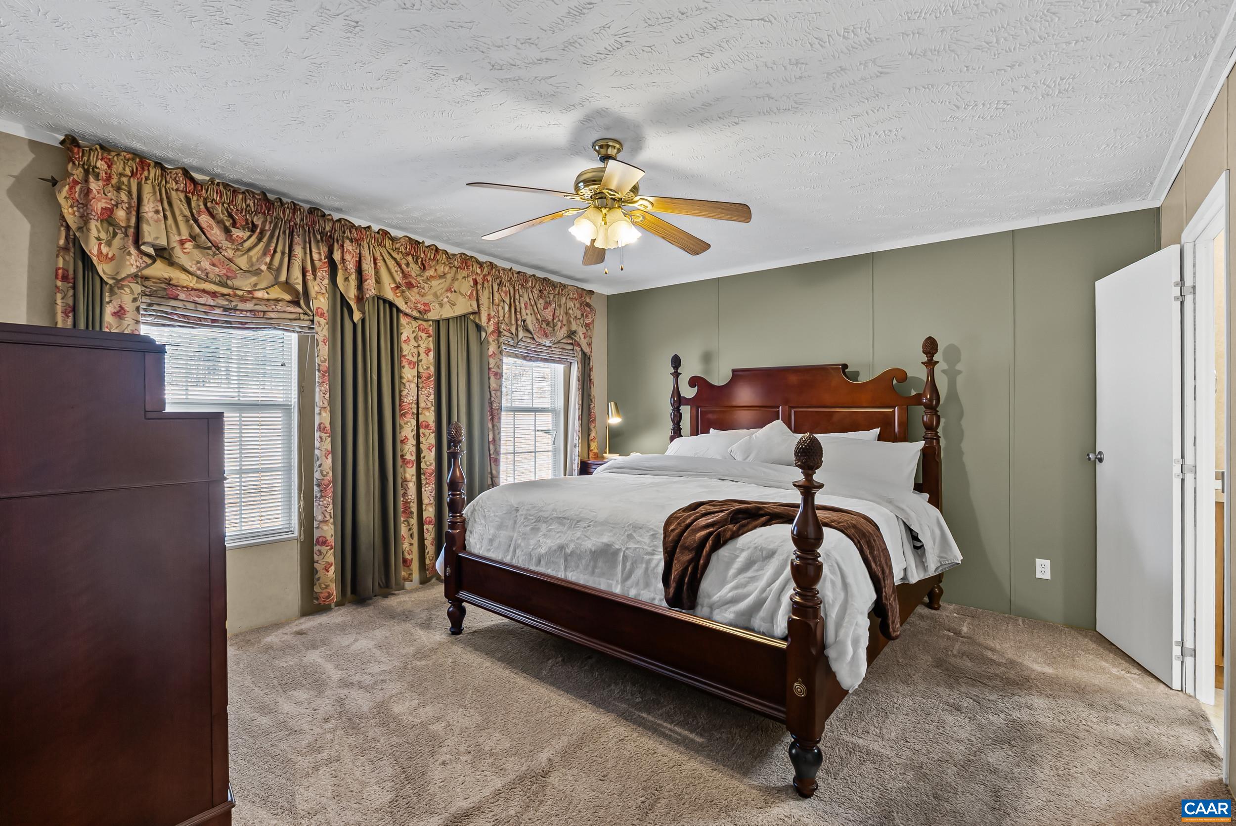 1690 Poorhouse Creek Road Appomattox, VA 24522 - Photo 13 of 44 a bed sitting in a bedroom next to a window