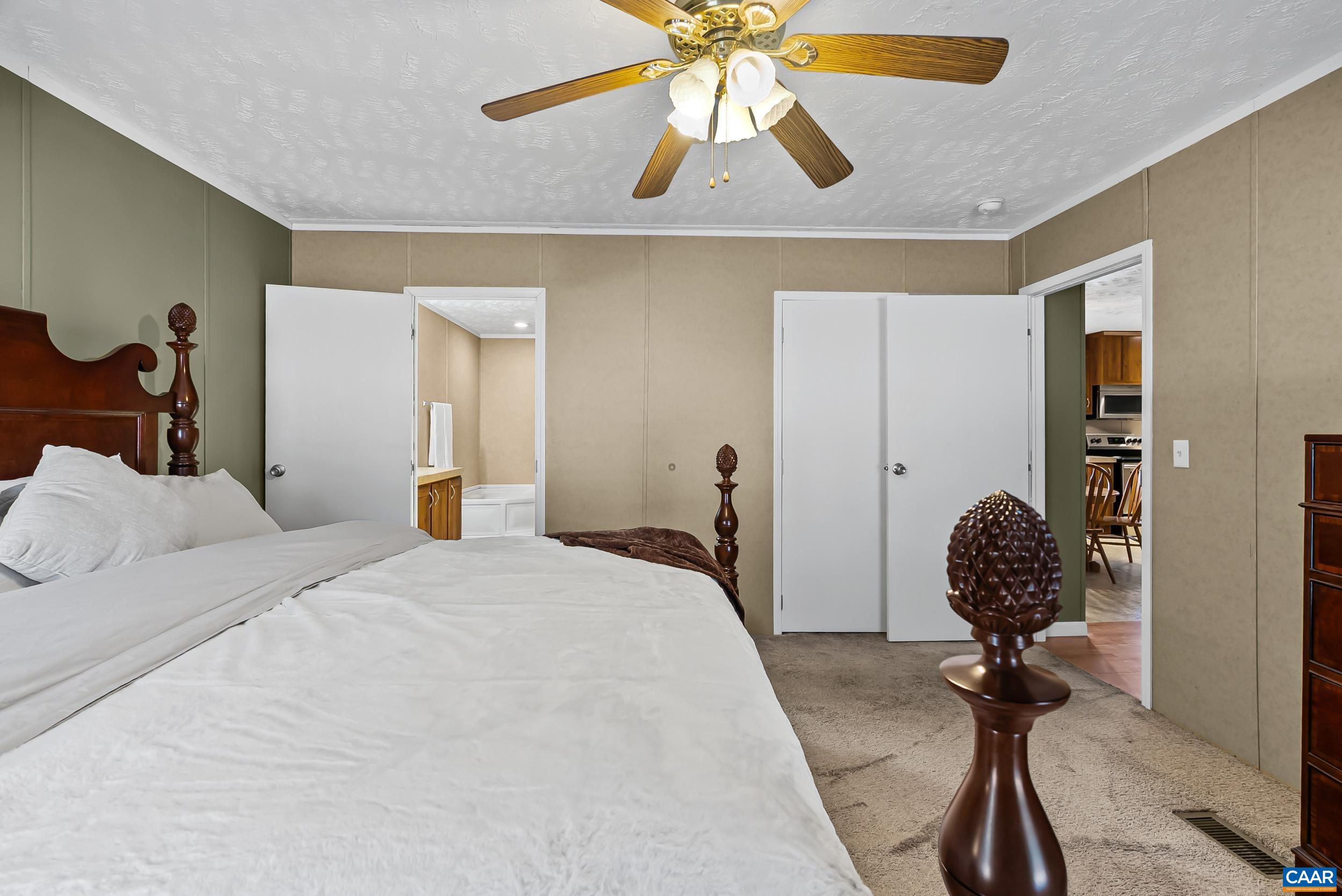 1690 Poorhouse Creek Road Appomattox, VA 24522 - Photo 14 of 44 a bedroom with a bed and a chandelier