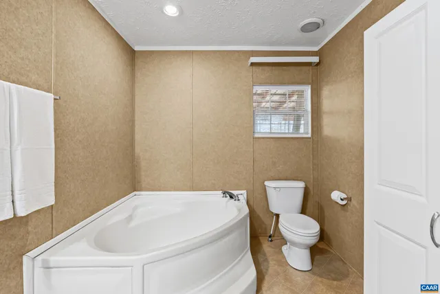 a bathroom with a shower and a room