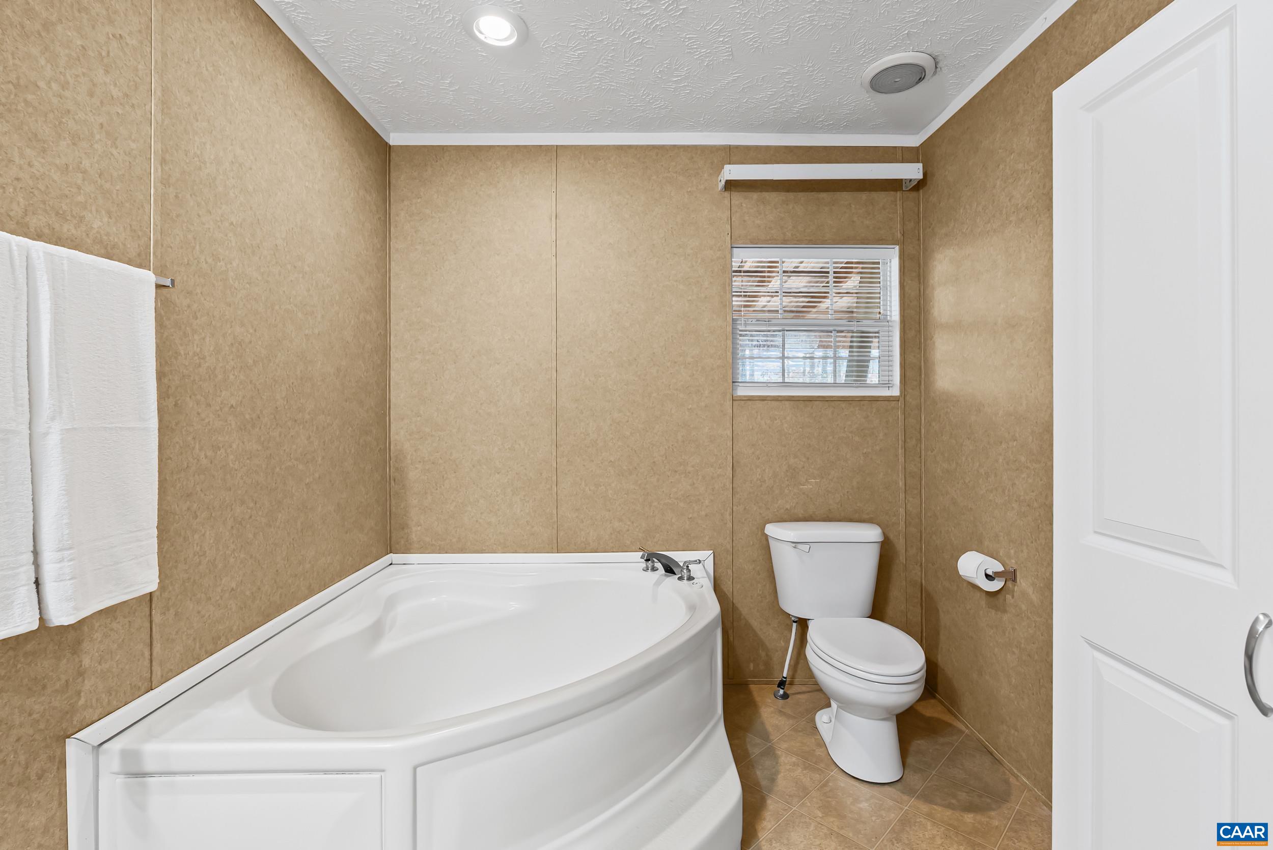 1690 Poorhouse Creek Road Appomattox, VA 24522 - Photo 16 of 44 a white toilet sitting next to a bathroom sink