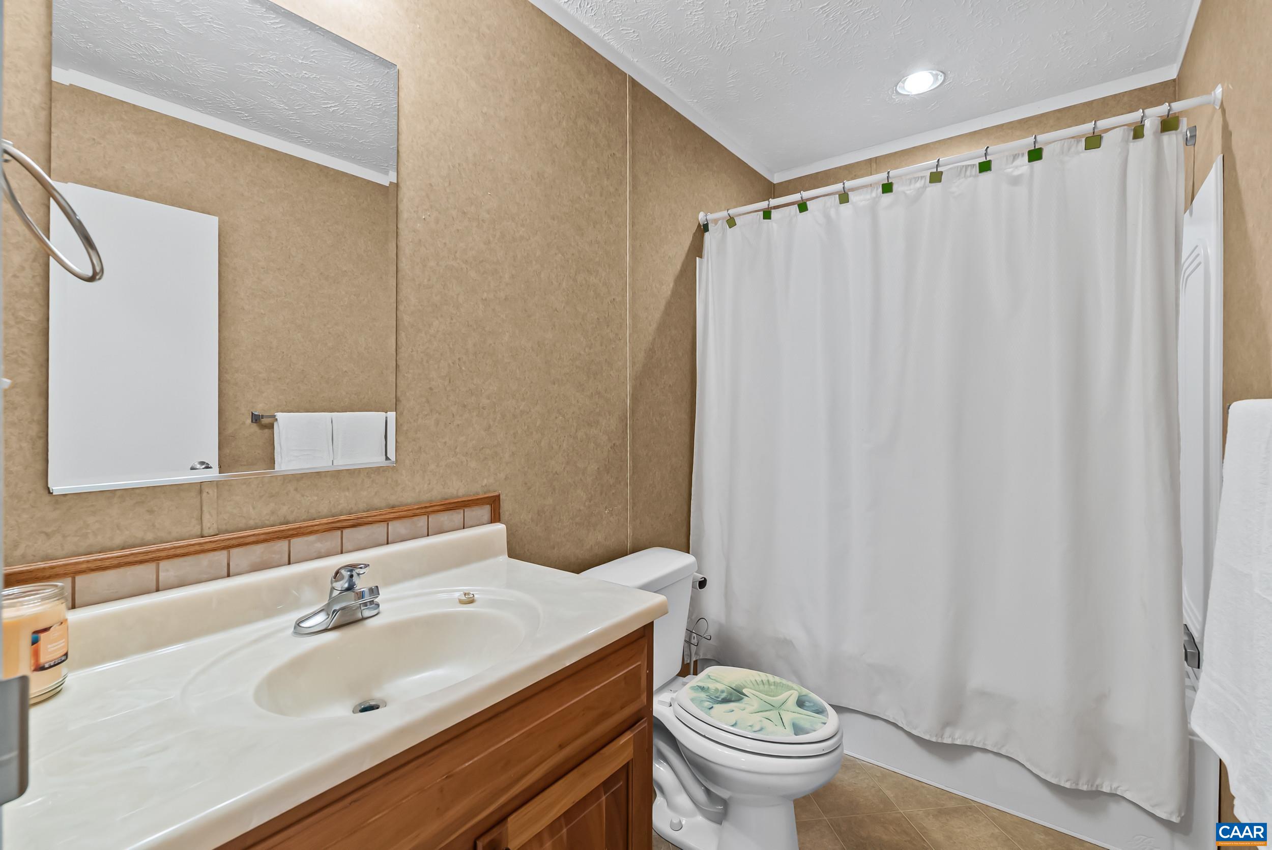 1690 Poorhouse Creek Road Appomattox, VA 24522 - Photo 18 of 44 a bathroom with a sink and a mirror