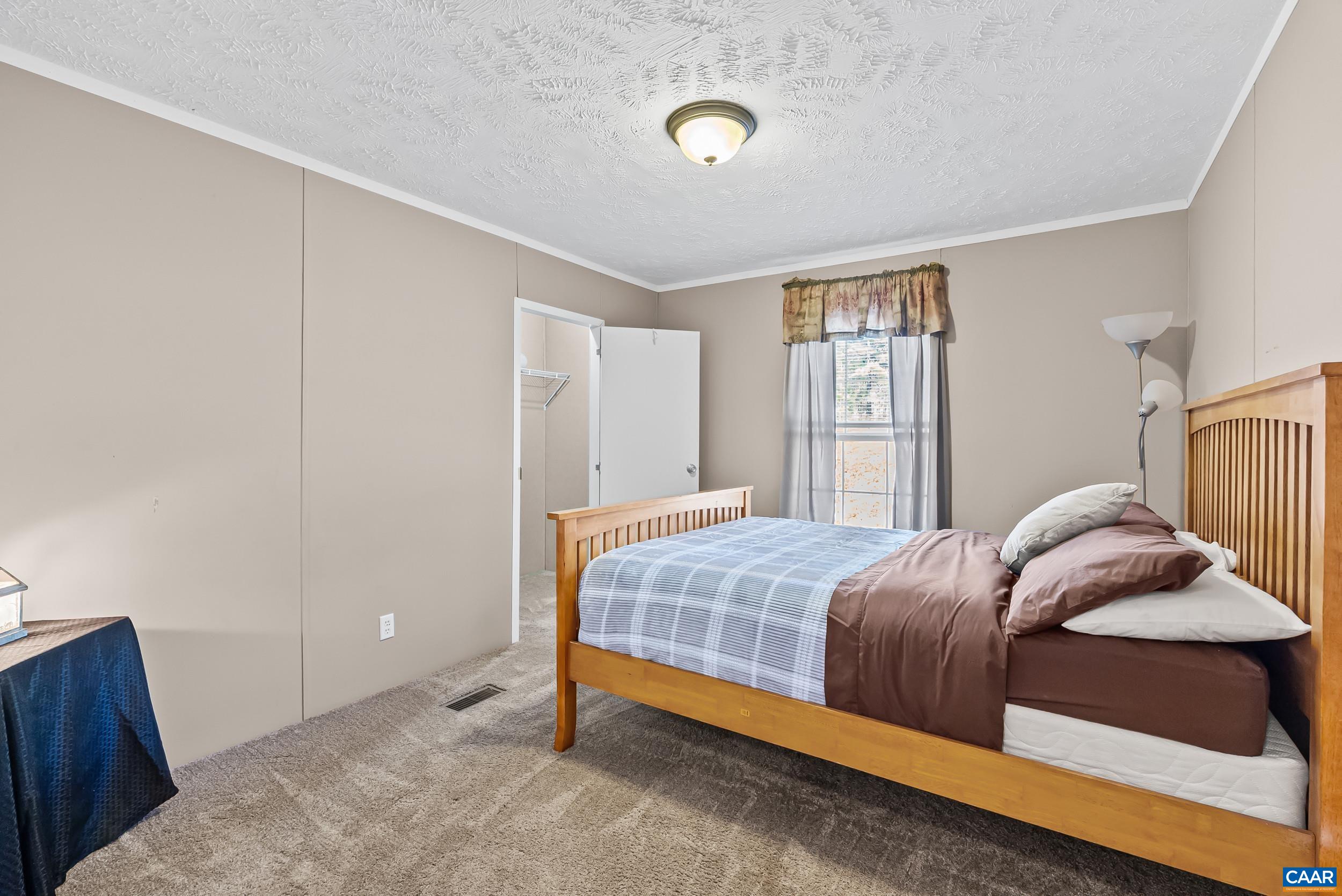 1690 Poorhouse Creek Road Appomattox, VA 24522 - Photo 19 of 44 a bedroom with a bed and wooden floor