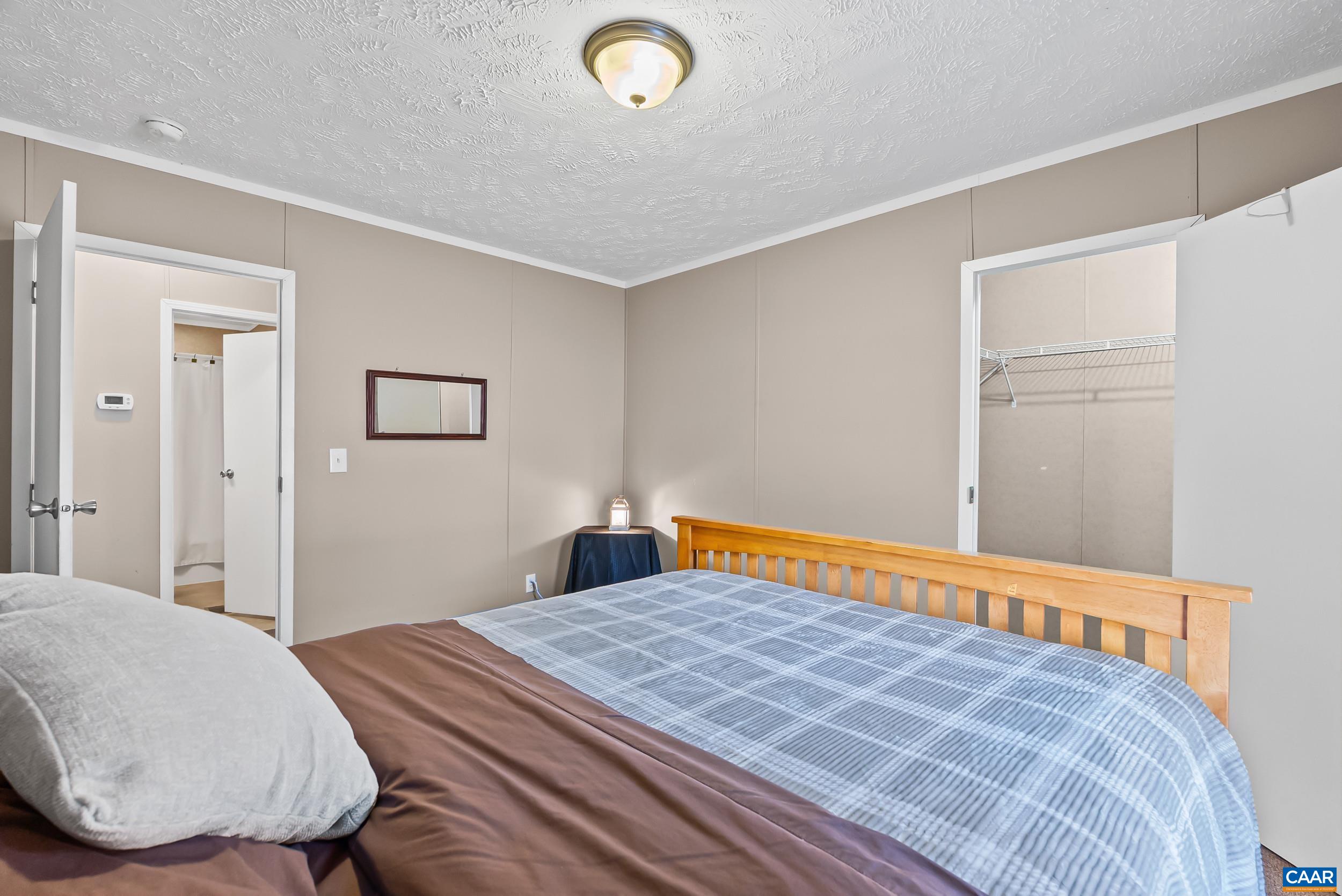 1690 Poorhouse Creek Road Appomattox, VA 24522 - Photo 20 of 44 a bedroom with a bed and a lamp