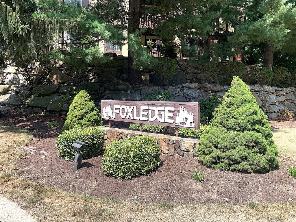 a sign that is sitting in front of flowers