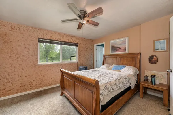 a bedroom with a bed and a window