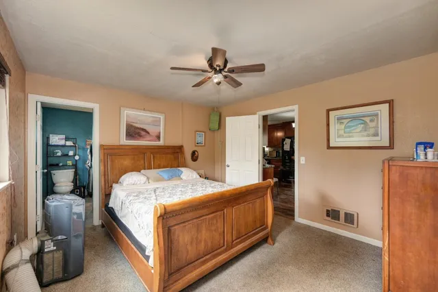 a bed room with a bed and a chandelier