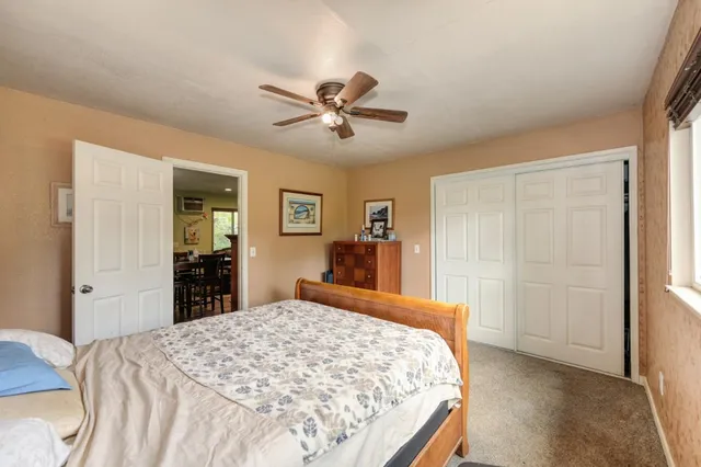 a bedroom with a large bed and a chandelier
