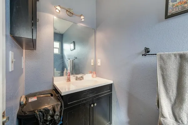 a bathroom with a sink toilet and a mirror