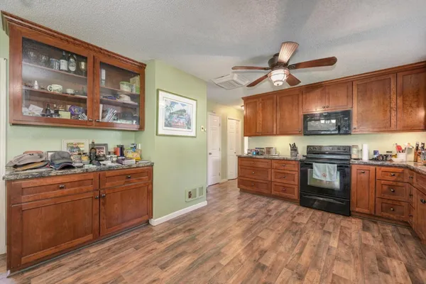 a kitchen with stainless steel appliances granite countertop a stove and cabinets