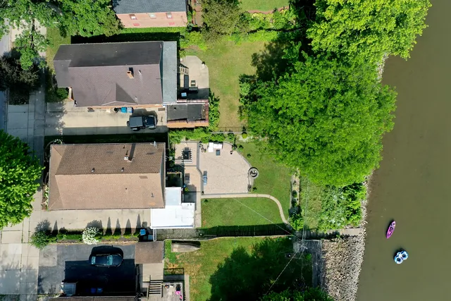 an aerial view of a house with a yard