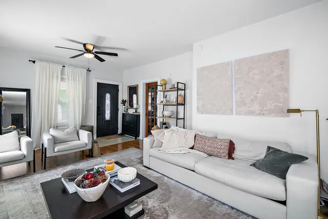 a living room with furniture rug and window