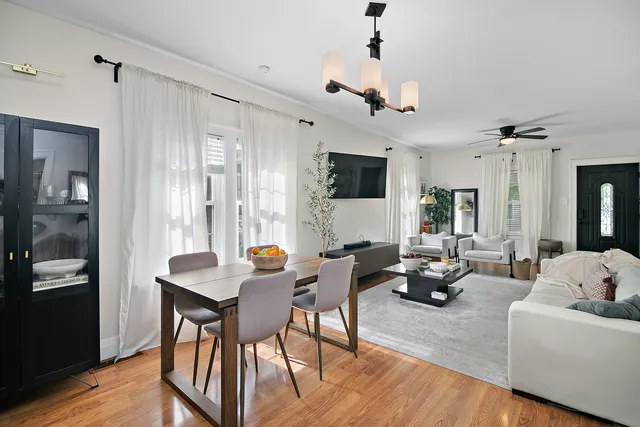 a living room with furniture a ceiling fan and a window