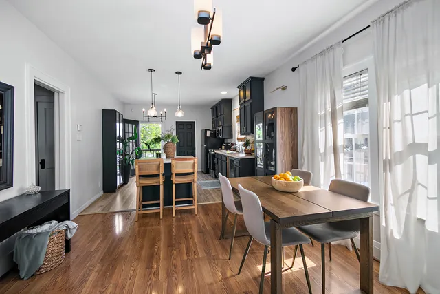 a view of a dining room with furniture window and wooden floor