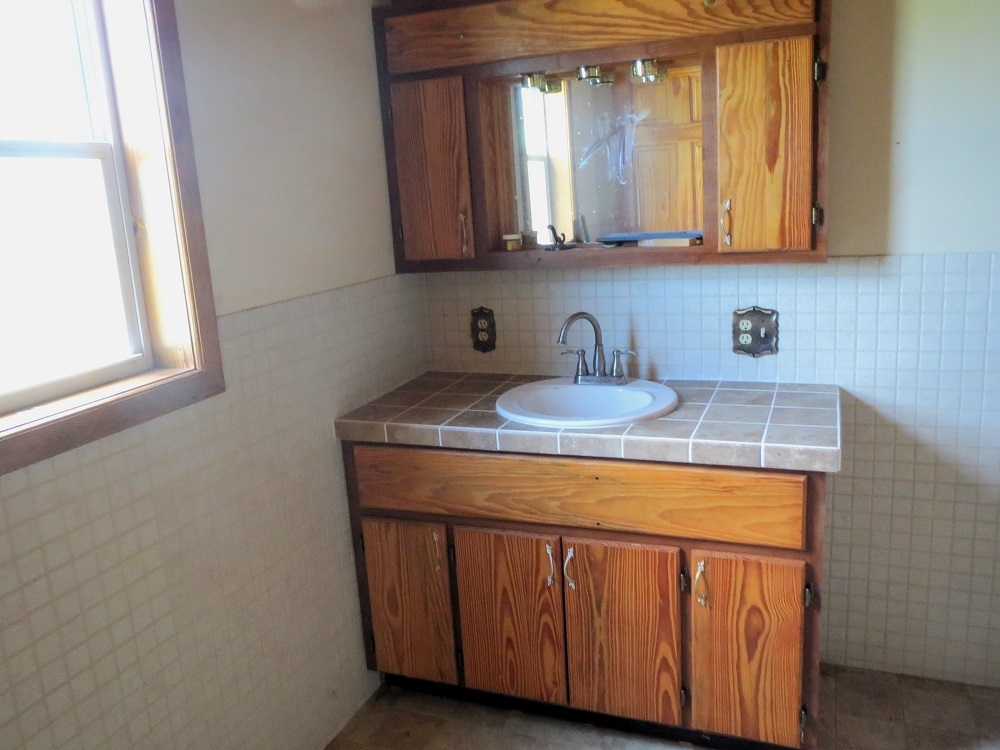 21785 Brooks Road Prophetstown, IL 61277 - Photo 27 of 38 a kitchen with granite countertop white cabinets and a stove