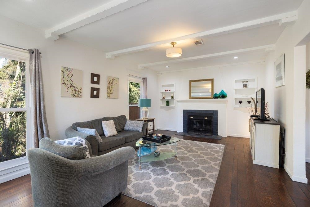9600 Golf Links Road Oakland, CA 94605 - Photo 13 of 47 Living room featuring beamed ceiling, dark wood-type flooring, and a brick fireplace