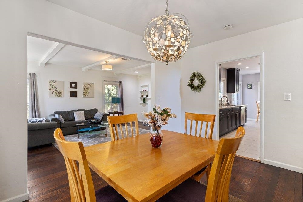 9600 Golf Links Road Oakland, CA 94605 - Photo 19 of 47 Dining space with dark wood-style floors, a chandelier, and beamed ceiling