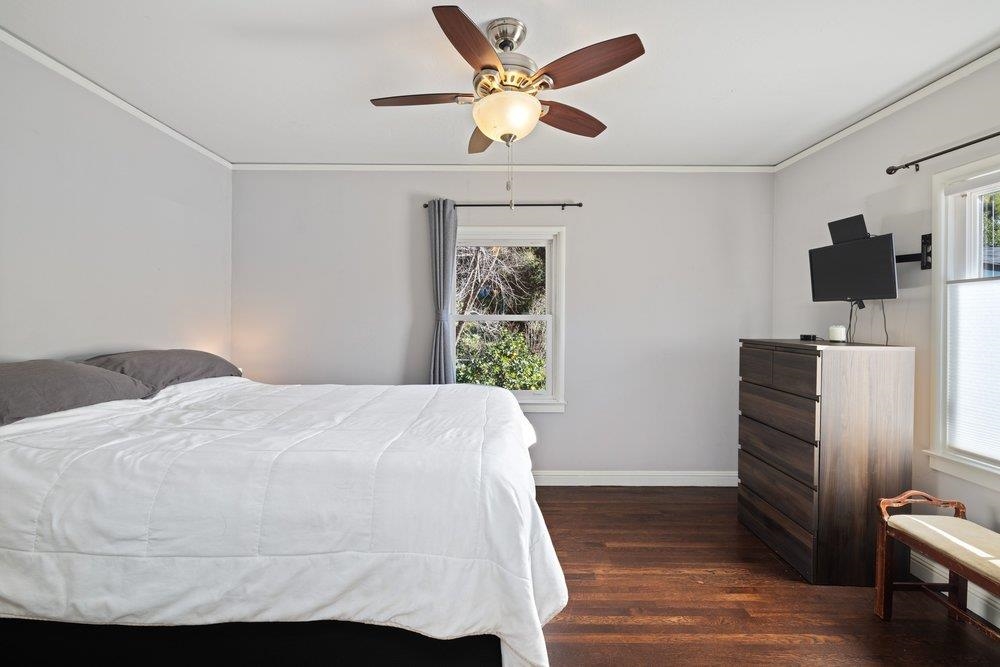9600 Golf Links Road Oakland, CA 94605 - Photo 22 of 47 Bedroom featuring crown molding, ceiling fan, and dark wood-type flooring