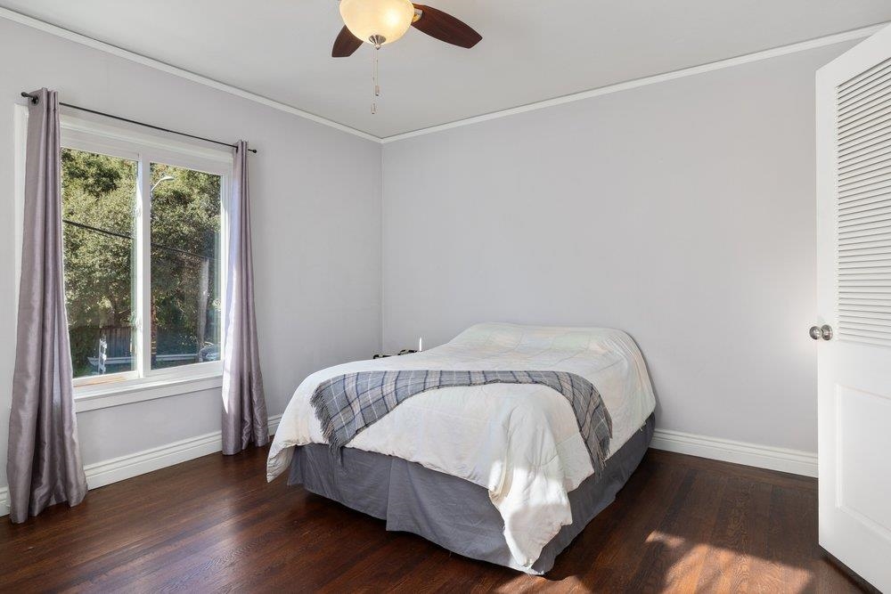 9600 Golf Links Road Oakland, CA 94605 - Photo 25 of 47 Bedroom featuring ornamental molding, dark wood-style floors, and a ceiling fan