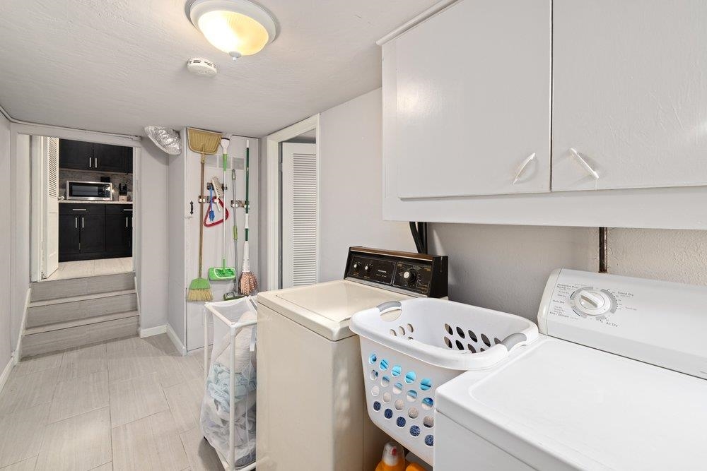 9600 Golf Links Road Oakland, CA 94605 - Photo 27 of 47 Laundry room with washer and dryer and baseboards