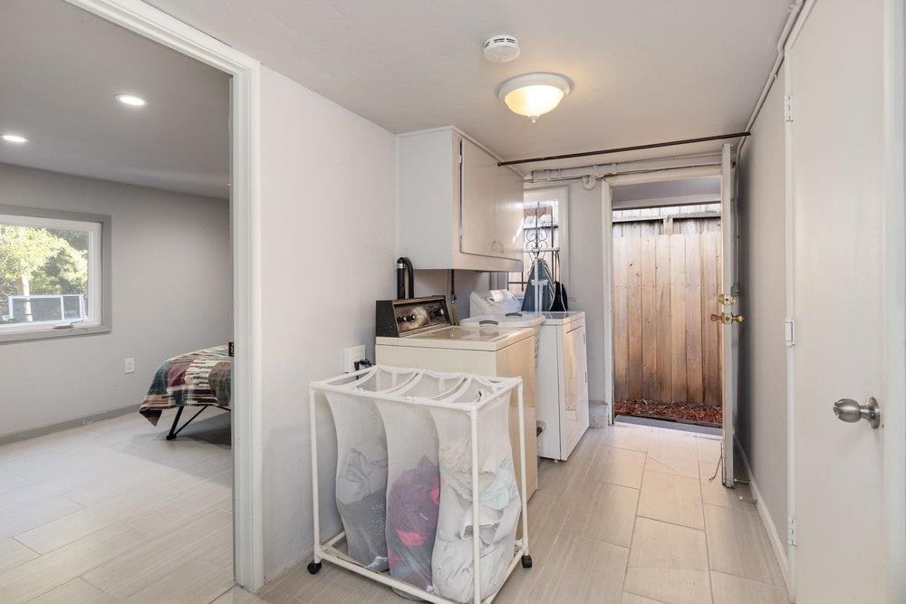 9600 Golf Links Road Oakland, CA 94605 - Photo 28 of 47 Laundry room featuring washer and clothes dryer and cabinet space