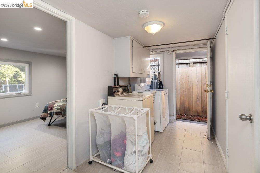 9600 Golf Links Road Oakland, CA 94605 - Photo 28 of 47 Laundry room featuring washer and clothes dryer and cabinet space