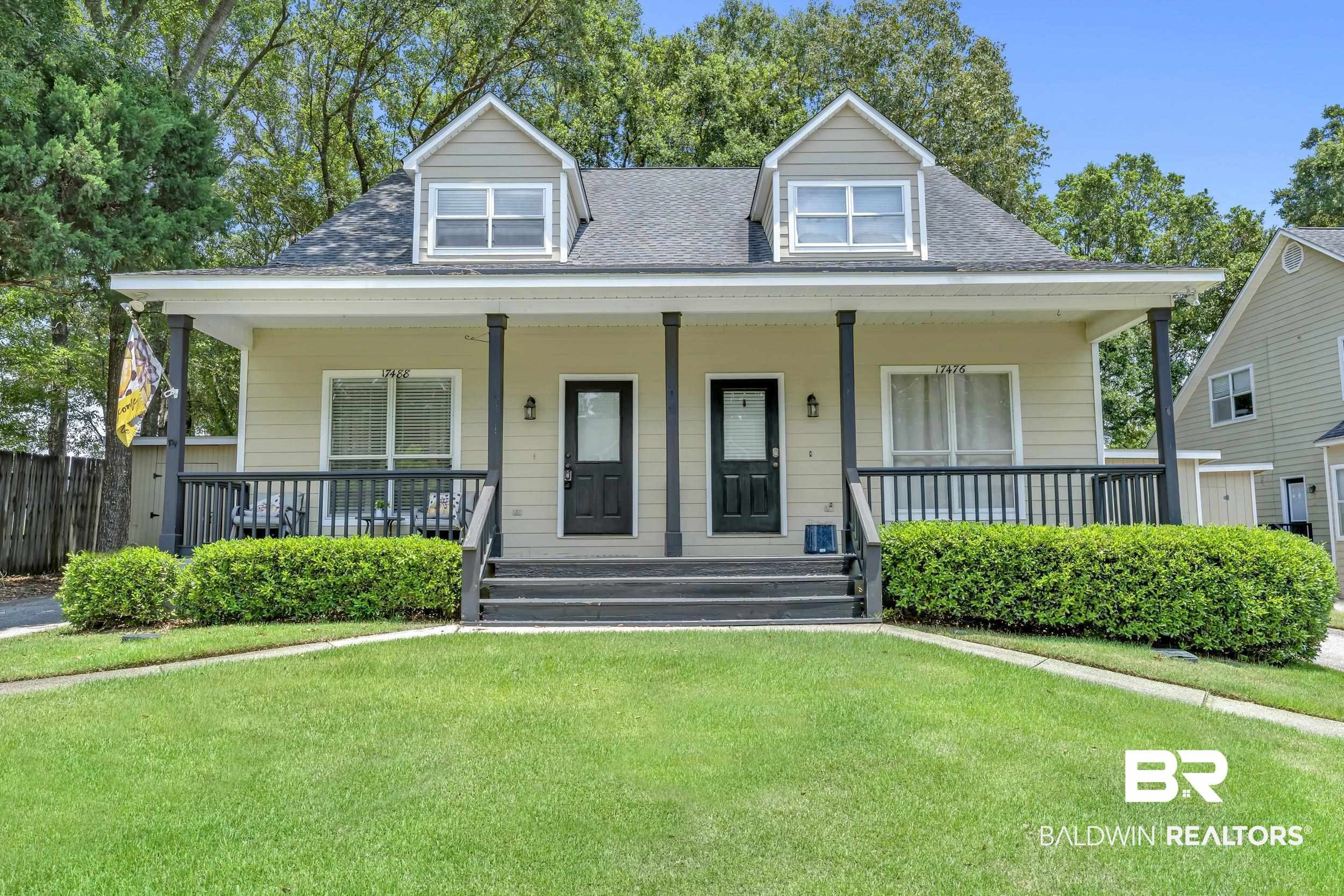 17488 Pandion Ridge, Unit A1 Fairhope, AL 36532 - Photo 2 of 18 Multi-family dwelling featuring a covered front porch with dark railings and columns, dormer windows, and a manicured lawn