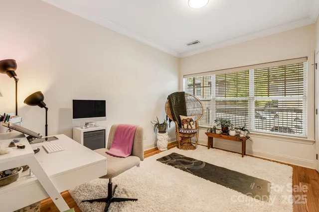 a view of a livingroom with workspace and a window
