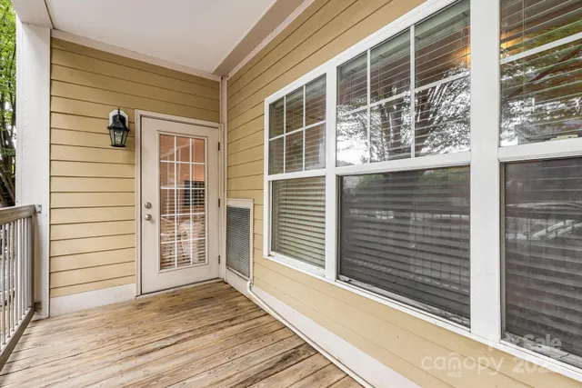 a view of a house with wooden floor and windows