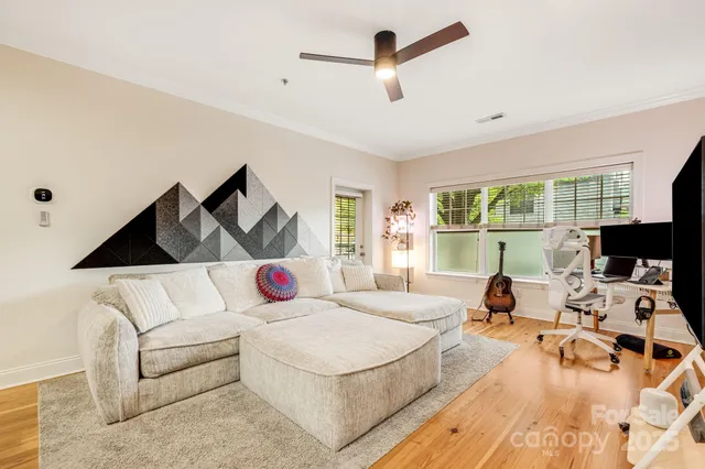 a bedroom with a bed a couch and a window