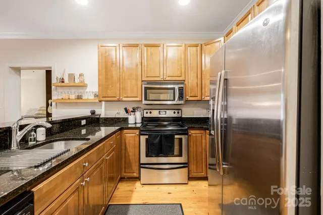 a kitchen with a sink stove and refrigerator