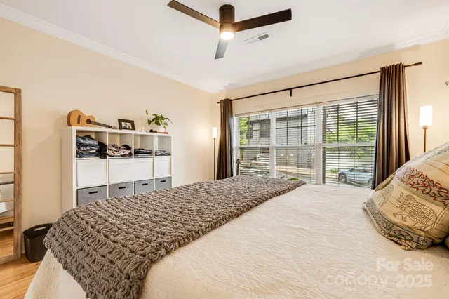 a bedroom with a bed and large window