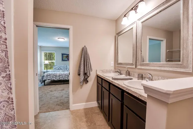 a en suite bathroom with a sink and a mirror