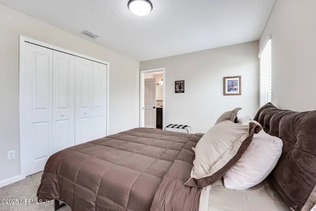 a bed room with a bed and a chair