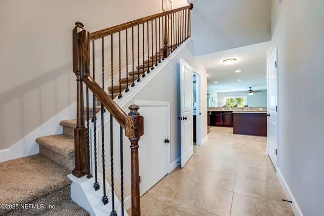 a view of a hallway with wooden floor and staircase