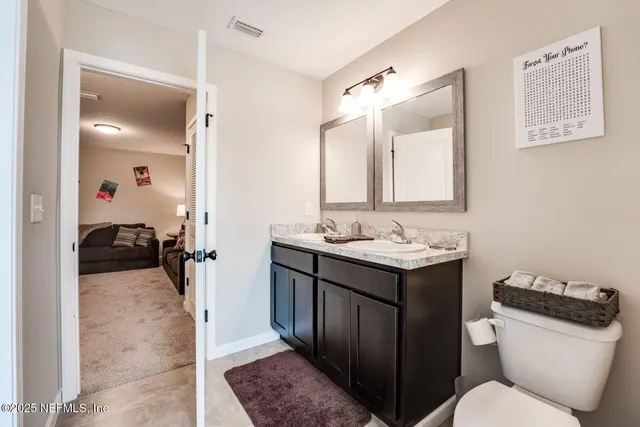 a bathroom with a toilet sink and mirror