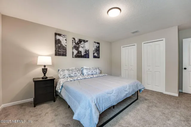 a bedroom with a bed and a night stand